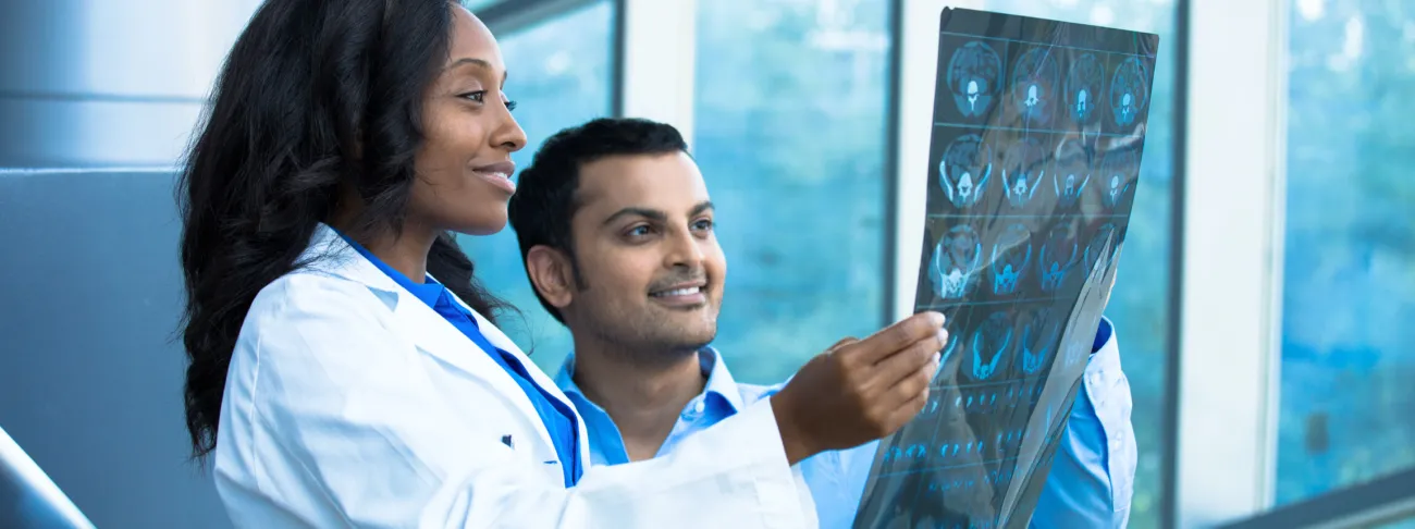 doctor and person looking at medical imaging together