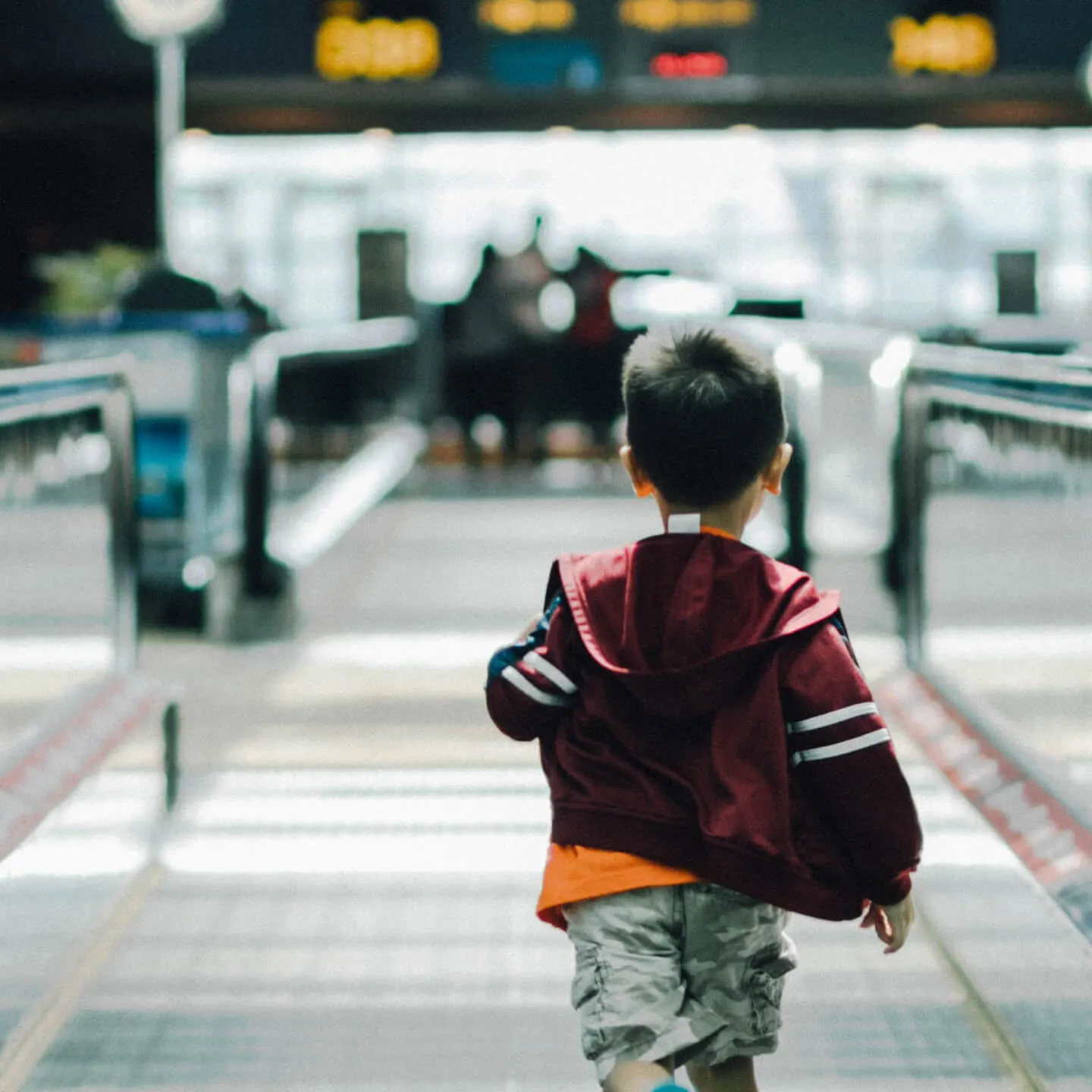 child running through airport