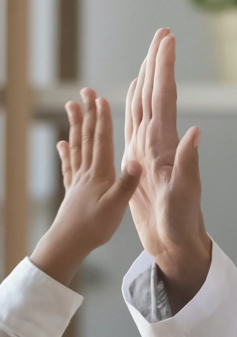 doctor and child hands doing a high five